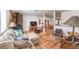 Inviting living room seamlessly flows into dining area with exposed brick fireplace at 5715 Gilbert Ln, Las Vegas, NV 89130