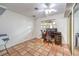 Home office with dark desk, tile floor, and a mirrored closet with natural light at 5715 Gilbert Ln, Las Vegas, NV 89130