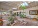 Large covered patio with skylights, a fountain, multiple seating areas, and brick flooring at 5715 Gilbert Ln, Las Vegas, NV 89130