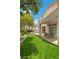 Backyard with lush lawn and a covered patio, perfect for outdoor dining at 575 Dusty Palms Ln, Henderson, NV 89052