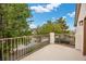 Balcony overlooking the neighborhood with trees and a glimpse of the pool on a clear and sunny day at 575 Dusty Palms Ln, Henderson, NV 89052