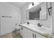Clean and modern bathroom featuring double sinks, marble countertops, and sleek black fixtures at 575 Dusty Palms Ln, Henderson, NV 89052