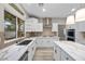 Modern kitchen featuring stainless steel appliances, quartz countertops, a gas range, and ample counter space at 575 Dusty Palms Ln, Henderson, NV 89052