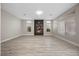 Spacious living room featuring a modern fireplace and wood-look flooring, bright and airy with natural light at 575 Dusty Palms Ln, Henderson, NV 89052
