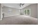Carpeted living room with large windows and a private outdoor balcony, creating a bright and airy atmosphere at 575 Dusty Palms Ln, Henderson, NV 89052