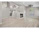 Spacious living room with high ceilings, wood-look floors, and open staircase at 575 Dusty Palms Ln, Henderson, NV 89052