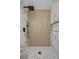Modern shower featuring a square shower head, with stone floors and beautiful marble look tile at 575 Dusty Palms Ln, Henderson, NV 89052