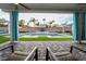 Resort-style backyard featuring a sparkling pool, artificial turf, and elegant outdoor furniture at 5865 Alice Landing Ct, Las Vegas, NV 89149
