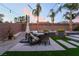 Inviting backyard patio features a dining set, ambient string lights, and drought-tolerant landscaping at 5865 Alice Landing Ct, Las Vegas, NV 89149
