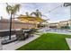 Inviting backyard with a pool, mature landscaping and seating area with a large patio umbrella at 5865 Alice Landing Ct, Las Vegas, NV 89149