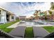 Well-appointed backyard featuring a pool, outdoor seating, mature landscaping, and covered patio at 5865 Alice Landing Ct, Las Vegas, NV 89149