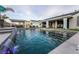 Backyard pool featuring a waterfall, fountain features, covered patios, and lounge furniture at 5865 Alice Landing Ct, Las Vegas, NV 89149