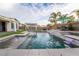 Beautiful backyard pool featuring waterfall features, lounge furniture and mature landscaping at 5865 Alice Landing Ct, Las Vegas, NV 89149
