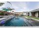 Backyard oasis with a pool featuring waterfall features, dining area, and a cabana at 5865 Alice Landing Ct, Las Vegas, NV 89149