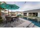 Resort style backyard pool featuring an outdoor kitchen and lounge areas at 5865 Alice Landing Ct, Las Vegas, NV 89149