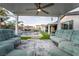 Stylish backyard featuring a comfortable seating area, a pool, a covered patio, and a well-manicured lawn at 5865 Alice Landing Ct, Las Vegas, NV 89149