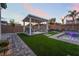 Backyard gazebo with seating, pool, pavers, synthetic grass and privacy fence at 5865 Alice Landing Ct, Las Vegas, NV 89149