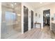 Bathroom featuring a glass shower, walk-in closet, and wooden floors at 5865 Alice Landing Ct, Las Vegas, NV 89149