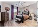 Nicely decorated bedroom with wood-look floors, neutral walls, and purple curtains at 5865 Alice Landing Ct, Las Vegas, NV 89149