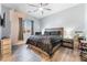 Cozy bedroom with a ceiling fan, neutral walls, and wood-look flooring at 5865 Alice Landing Ct, Las Vegas, NV 89149