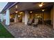 Enjoy an expansive covered patio with multiple seating areas, ceiling fans, and beautiful tile flooring at 5865 Alice Landing Ct, Las Vegas, NV 89149