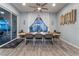 Modern dining room with a wooden table, seating for eight, and natural light from large windows at 5865 Alice Landing Ct, Las Vegas, NV 89149