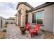Cozy front patio with stone pillars, seating, a fire pit, and a well-maintained exterior at 5865 Alice Landing Ct, Las Vegas, NV 89149