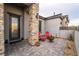 Inviting front patio area with stone accents, comfortable seating, and well-maintained landscaping at 5865 Alice Landing Ct, Las Vegas, NV 89149