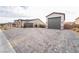 Large paved driveway leading to a spacious three-car garage in a single-story home at 5865 Alice Landing Ct, Las Vegas, NV 89149
