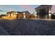 Spacious driveway with a large garage featuring stone accents and exterior lighting at 5865 Alice Landing Ct, Las Vegas, NV 89149