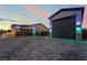 Spacious three-car garage with large paved driveway and exterior lighting at 5865 Alice Landing Ct, Las Vegas, NV 89149