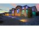 Beautiful home exterior with stone accents, decorative lighting, and well-maintained landscaping at 5865 Alice Landing Ct, Las Vegas, NV 89149