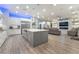Modern kitchen open to the living room, featuring stainless steel appliances and an island at 5865 Alice Landing Ct, Las Vegas, NV 89149