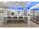 Kitchen island featuring stainless steel appliances, white cabinets and bar seating at 5865 Alice Landing Ct, Las Vegas, NV 89149