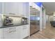 Kitchenette features stainless steel fridge, white cabinets and a black countertop at 5865 Alice Landing Ct, Las Vegas, NV 89149