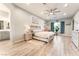 Serene bedroom with hardwood floors, a king-sized bed, and decor, and an ensuite bathroom at 5865 Alice Landing Ct, Las Vegas, NV 89149
