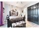 Cozy main bedroom featuring a wrought iron bed frame, unique animal print accents, and an ensuite bath at 5865 Alice Landing Ct, Las Vegas, NV 89149