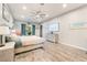 Comfortable bedroom with hardwood floors, a king-sized bed, decor, and a large screen TV at 5865 Alice Landing Ct, Las Vegas, NV 89149