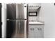 Butler's pantry featuring stainless steel refrigerator, granite counters, a sink, gray cabinets and ample storage at 5865 Alice Landing Ct, Las Vegas, NV 89149
