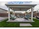 Beautiful backyard pergola with comfortable blue outdoor furniture, ceiling fan, and a tranquil setting at 5865 Alice Landing Ct, Las Vegas, NV 89149