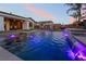 Lounge by the pool, complemented by an outdoor kitchen, ample seating, and lush landscaping for relaxing outdoors at 5865 Alice Landing Ct, Las Vegas, NV 89149