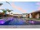 Beautiful in-ground pool with waterfall feature, ambient lighting, and an outdoor kitchen for ultimate relaxation at 5865 Alice Landing Ct, Las Vegas, NV 89149