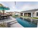 This backyard features a stunning in-ground pool, a covered patio, and ample seating for outdoor entertaining at 5865 Alice Landing Ct, Las Vegas, NV 89149