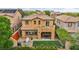 Backyard features a covered patio, artificial turf, and lush landscaping at 617 Apricot Rose Pl, Las Vegas, NV 89138