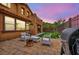 This cozy backyard has a barbecue, seating, and a patch of artificial grass at 617 Apricot Rose Pl, Las Vegas, NV 89138
