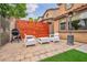 A backyard with green artificial turf, a modern wooden fence and outdoor seating at 617 Apricot Rose Pl, Las Vegas, NV 89138