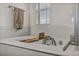 Bright bathroom features a luxurious soaking tub with a stylish wooden tray at 617 Apricot Rose Pl, Las Vegas, NV 89138