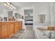 Primary bath features a vanity with double sinks, tub and a bedroom entrance at 617 Apricot Rose Pl, Las Vegas, NV 89138
