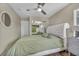 Inviting bedroom features a tufted headboard, ceiling fan, and mirrored closet for a cozy retreat at 617 Apricot Rose Pl, Las Vegas, NV 89138