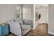 Cozy bedroom sitting area offers a comfortable chair and a view into the luxurious bathroom at 617 Apricot Rose Pl, Las Vegas, NV 89138